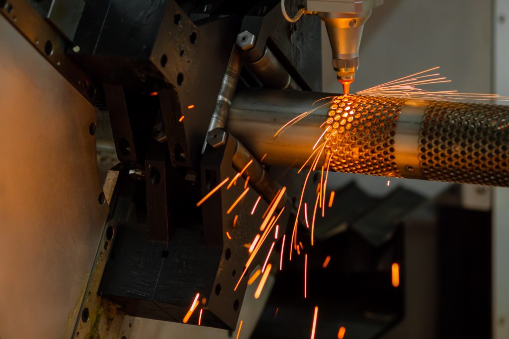 Laser cutting machine working with metal workpiece with sparks - Fabronex